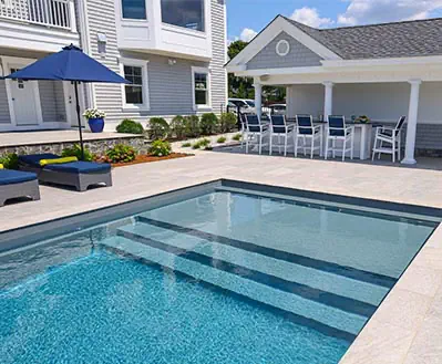A Leisure Pools fiberglass swimming pool in Graphite Grey color