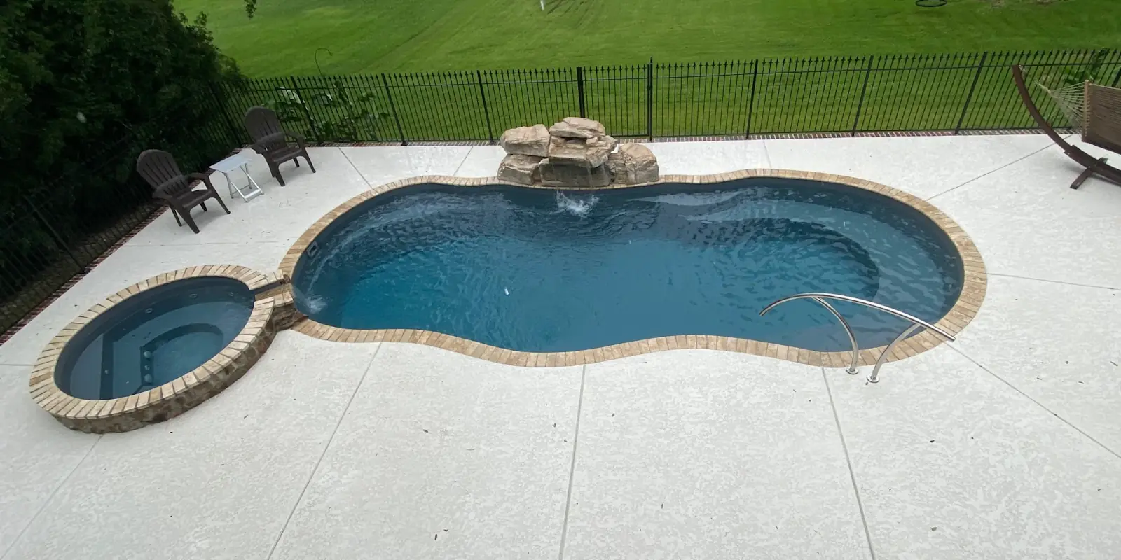 A backyard swimming pool installed by Backyard Paradise Pools